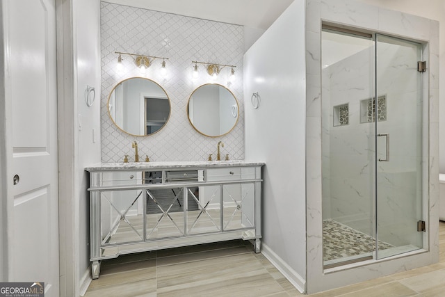 bathroom with vanity, backsplash, a shower with shower door, and tile patterned floors