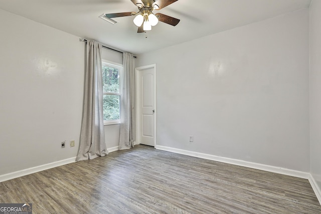 spare room featuring ceiling fan and wood-type flooring