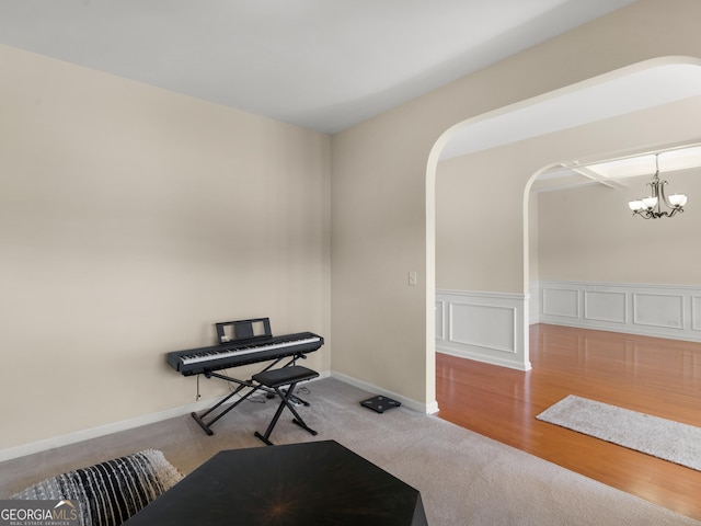 interior space with light carpet and a chandelier