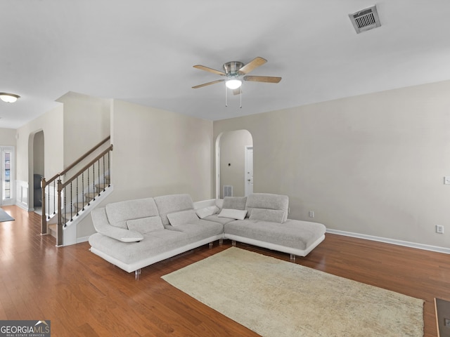 living room featuring ceiling fan and hardwood / wood-style floors