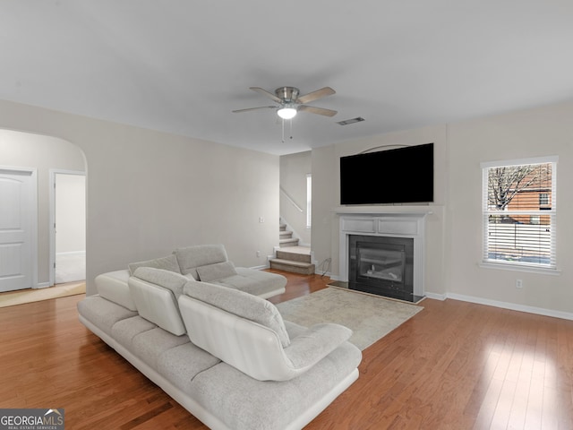 living room featuring hardwood / wood-style flooring and ceiling fan