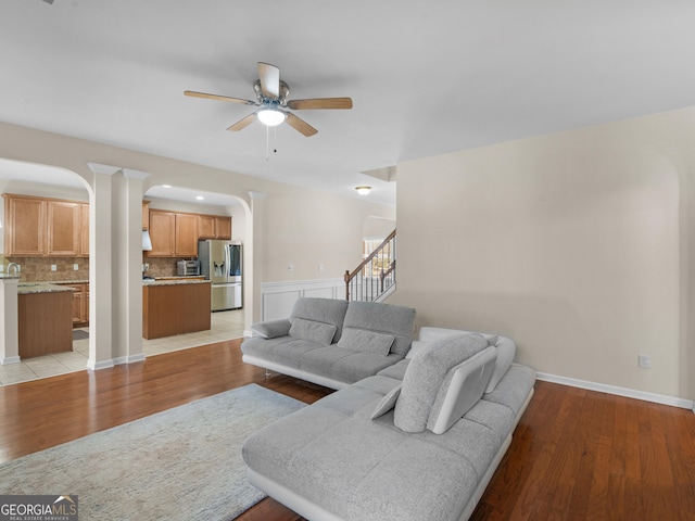 living room featuring ceiling fan and light wood-type flooring