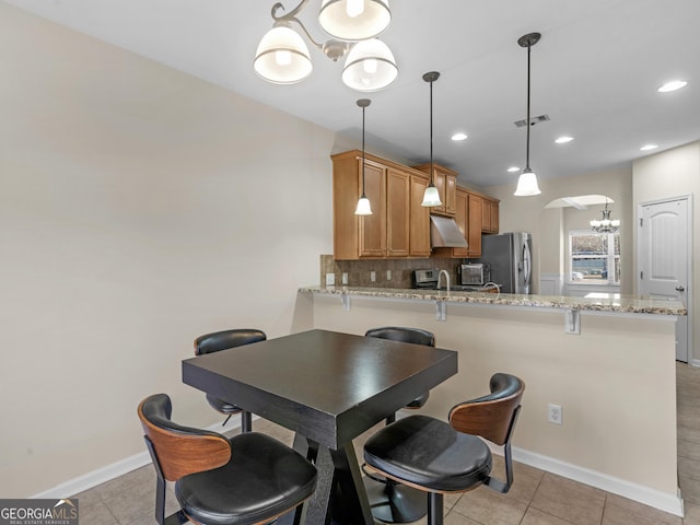 tiled dining area featuring a notable chandelier