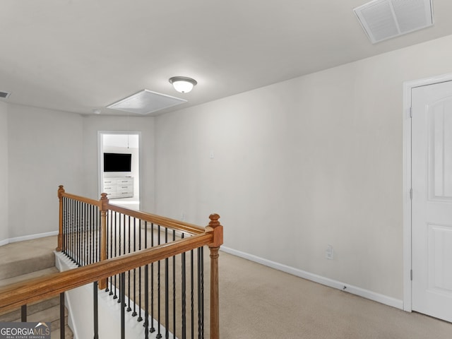 corridor with light colored carpet