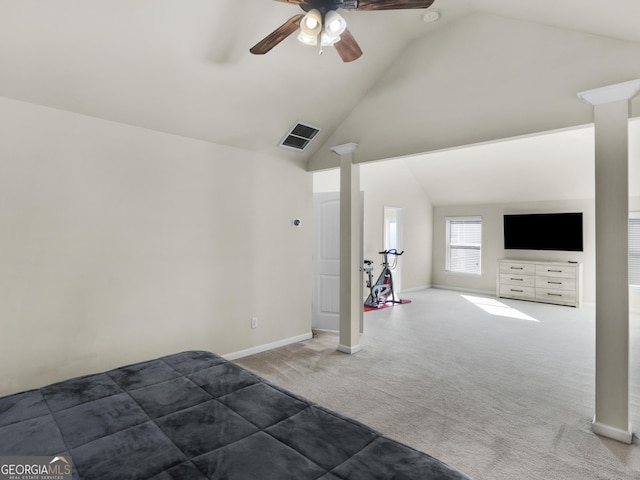 unfurnished bedroom with carpet floors, ornate columns, ceiling fan, and vaulted ceiling