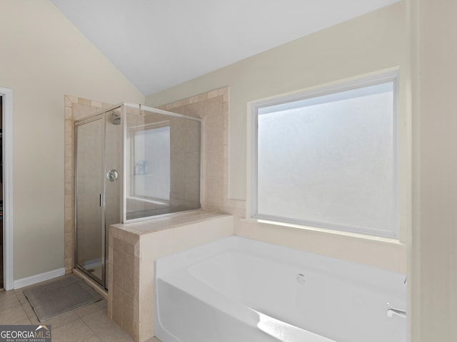 bathroom with lofted ceiling, tile patterned flooring, and separate shower and tub