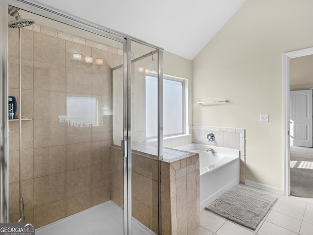 bathroom featuring tile patterned flooring, vaulted ceiling, and shower with separate bathtub