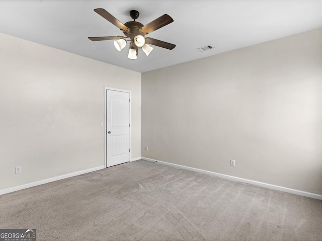 carpeted spare room with ceiling fan