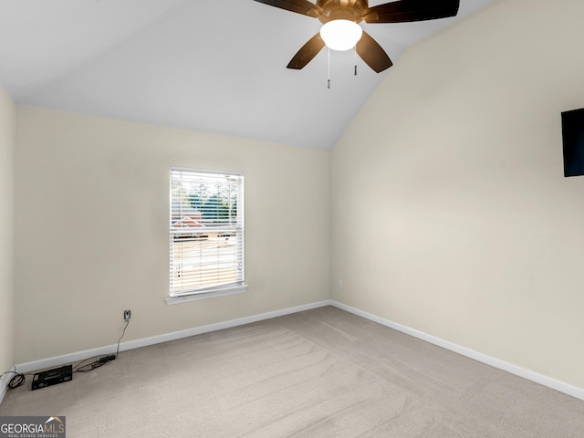 carpeted spare room with lofted ceiling and ceiling fan