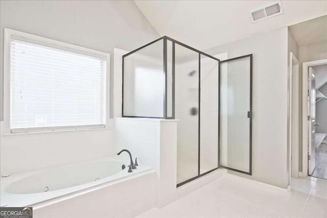 bathroom featuring shower with separate bathtub