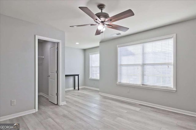 empty room featuring ceiling fan and light hardwood / wood-style flooring