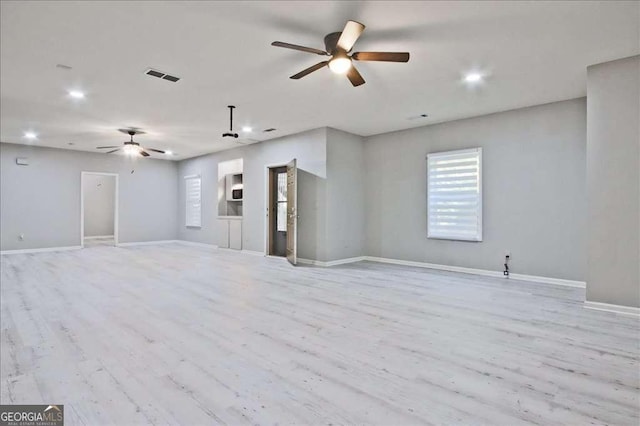 unfurnished living room featuring light hardwood / wood-style floors and ceiling fan