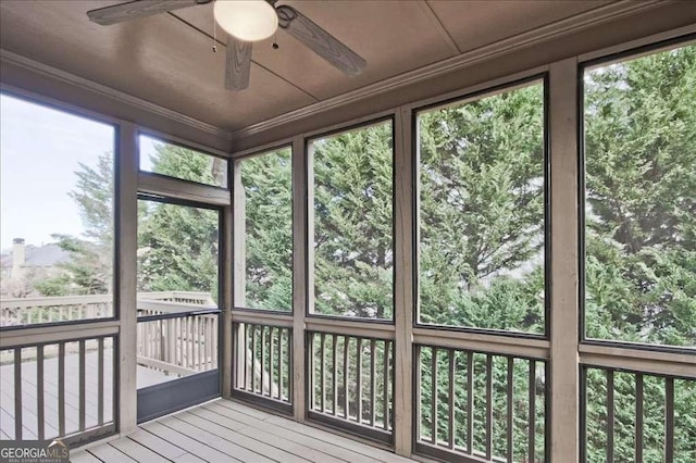 unfurnished sunroom with ceiling fan