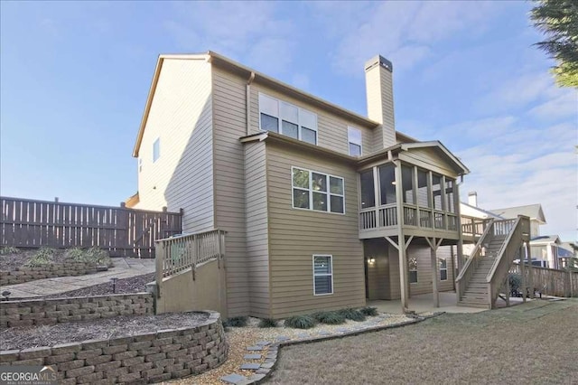 back of house with a patio, a deck, and a sunroom