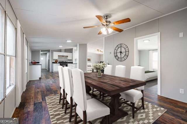 dining room with crown molding, ceiling fan, lofted ceiling, and dark hardwood / wood-style floors