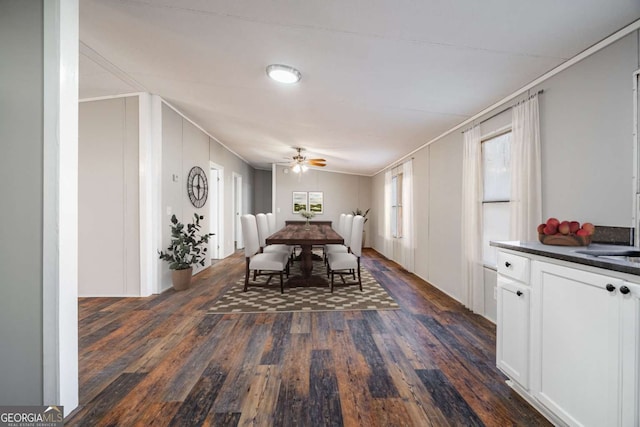 unfurnished dining area with ornamental molding, dark wood-type flooring, and ceiling fan