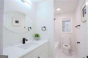 bathroom with vanity and a tub