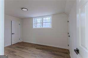 bathroom featuring vanity, walk in shower, and toilet