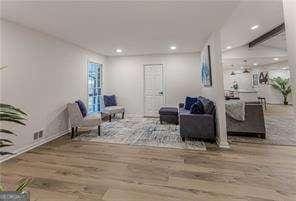 interior space with wood-type flooring and beam ceiling