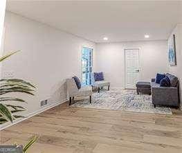 sitting room with hardwood / wood-style floors