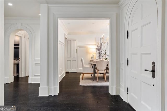 corridor featuring crown molding and dark hardwood / wood-style flooring