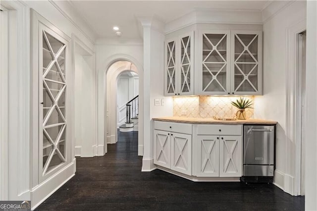 hallway featuring ornamental molding and dark wood-type flooring