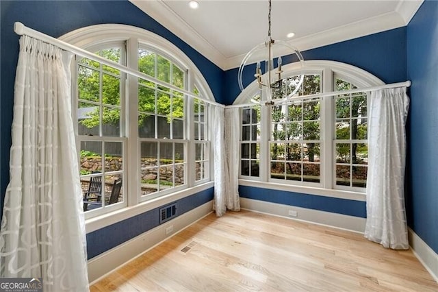 sitting room featuring built in shelves, crown molding, french doors, and a fireplace