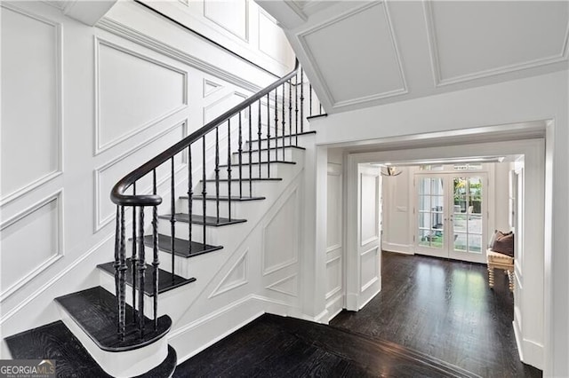 stairway with french doors, crown molding, and hardwood / wood-style flooring