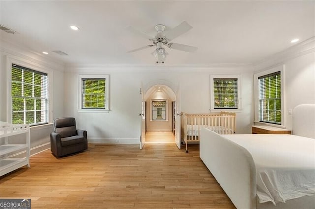 bedroom featuring baseboards, recessed lighting, ornamental molding, and light wood-style flooring