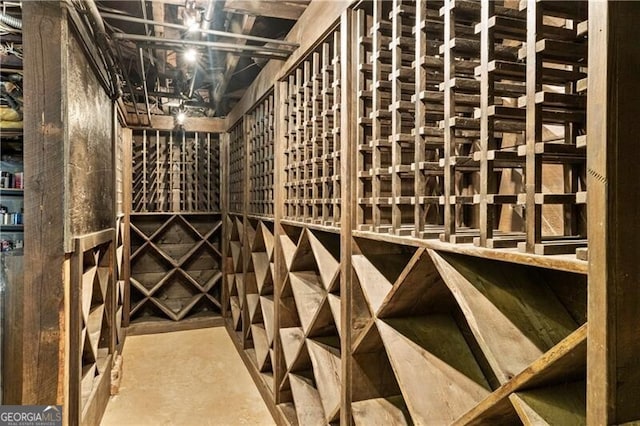 wine area featuring concrete floors