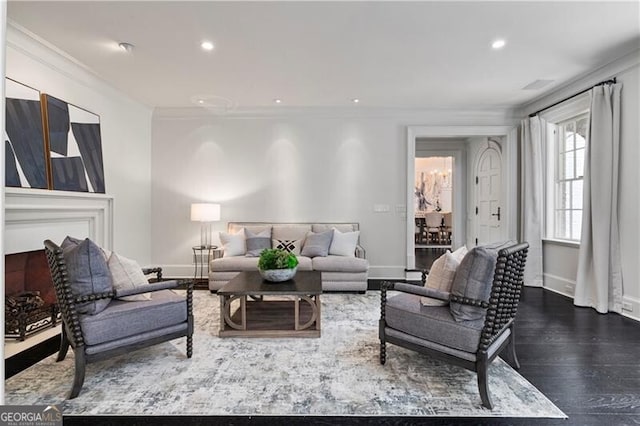 living room featuring wood-type flooring and ornamental molding