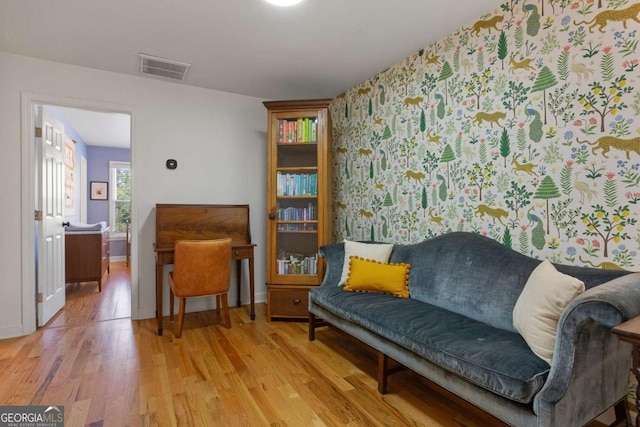 sitting room with hardwood / wood-style flooring