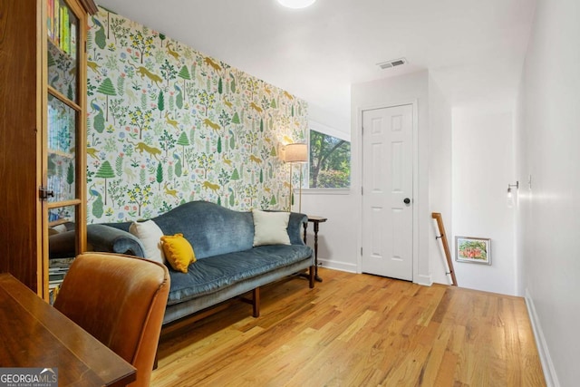 living area with hardwood / wood-style flooring