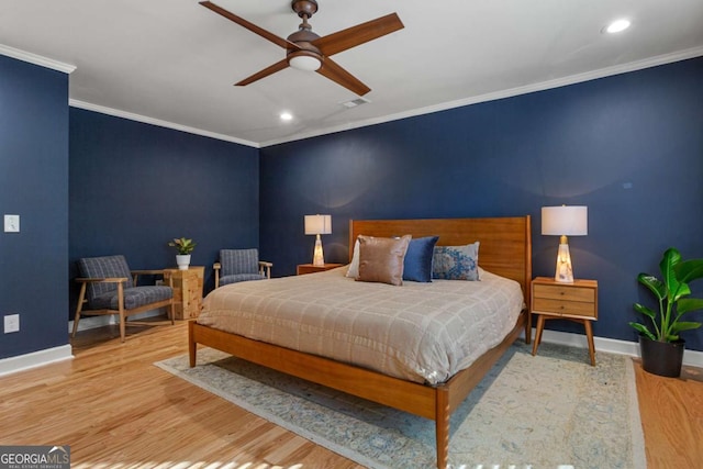 bedroom with wood-type flooring, ornamental molding, and ceiling fan