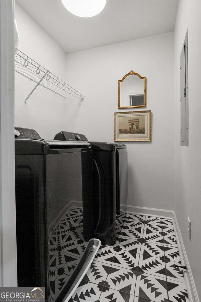 laundry room featuring electric panel and washer and dryer