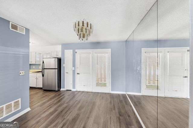 interior space with dark hardwood / wood-style flooring and a textured ceiling