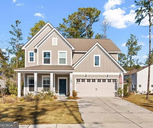 craftsman house featuring a garage and a front lawn