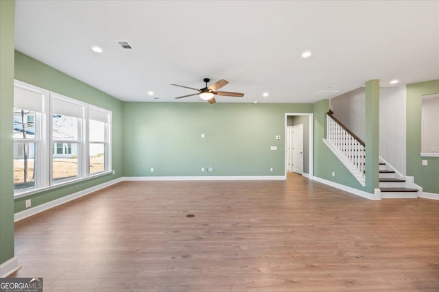 unfurnished living room featuring ceiling fan and light hardwood / wood-style flooring