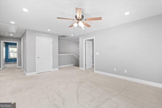 carpeted spare room featuring ceiling fan