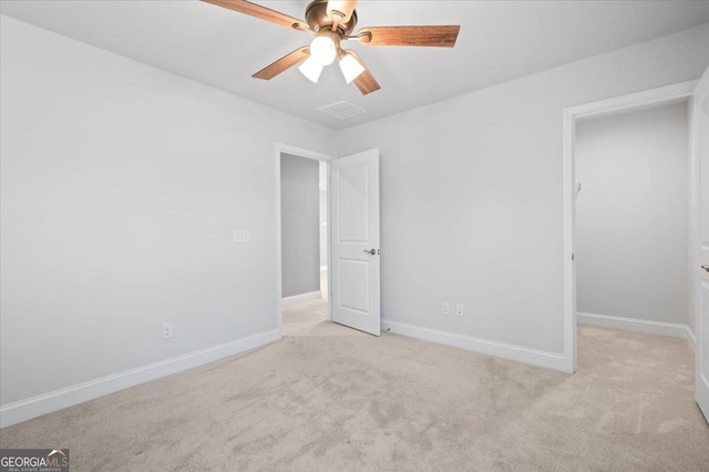 unfurnished bedroom with light colored carpet and ceiling fan