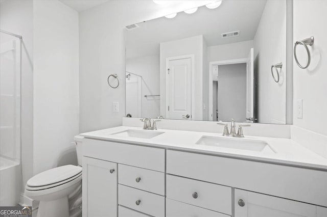 bathroom with vanity, toilet, and a shower