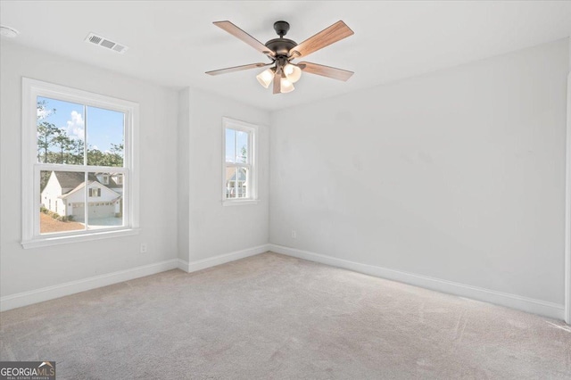 spare room featuring ceiling fan and light colored carpet