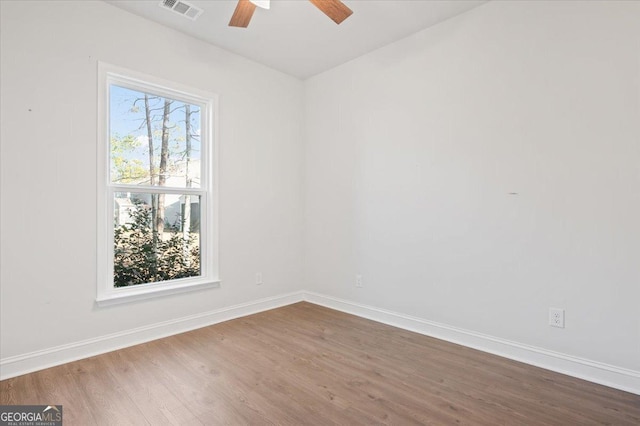 unfurnished room with ceiling fan and wood-type flooring