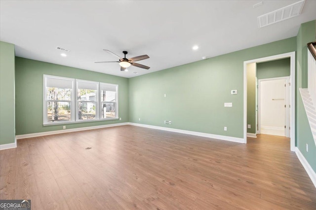 empty room with ceiling fan and light wood-type flooring