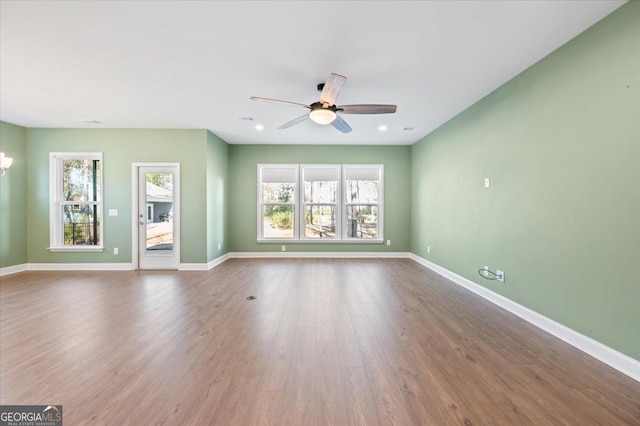 spare room featuring ceiling fan, plenty of natural light, and hardwood / wood-style floors