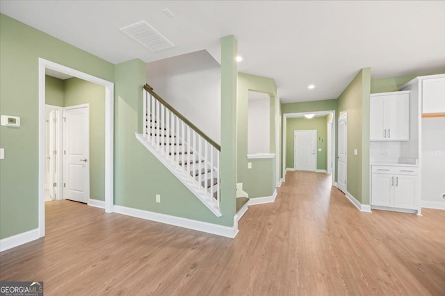 foyer entrance with light wood-type flooring