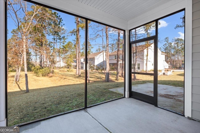 unfurnished sunroom with wooden ceiling and a healthy amount of sunlight