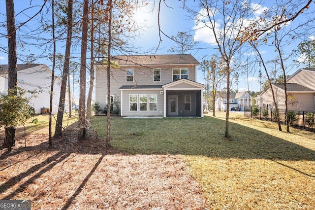 rear view of property featuring a yard