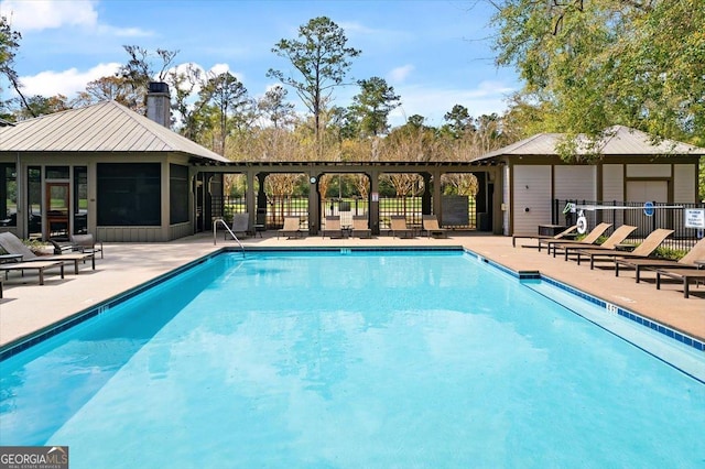 view of swimming pool featuring a gazebo and a sunroom