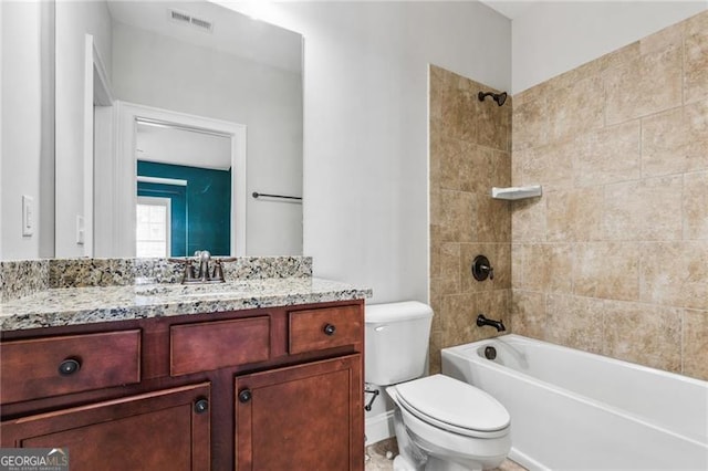 bathroom featuring visible vents, vanity, toilet, and shower / bathtub combination